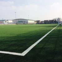 Football training at Whitefield School near Brent Cross, London, with young athletes practicing on a professional-grade pitch.